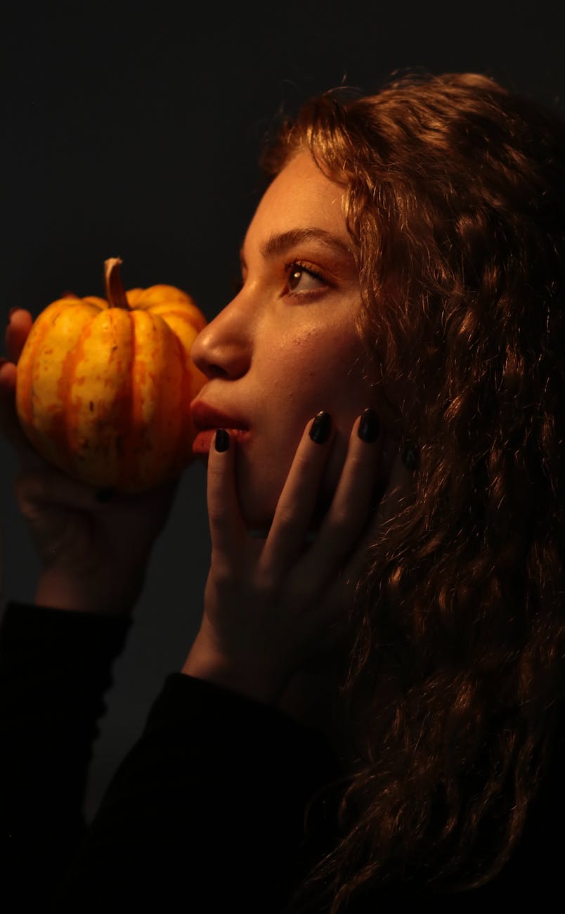redhead woman with pumpkin