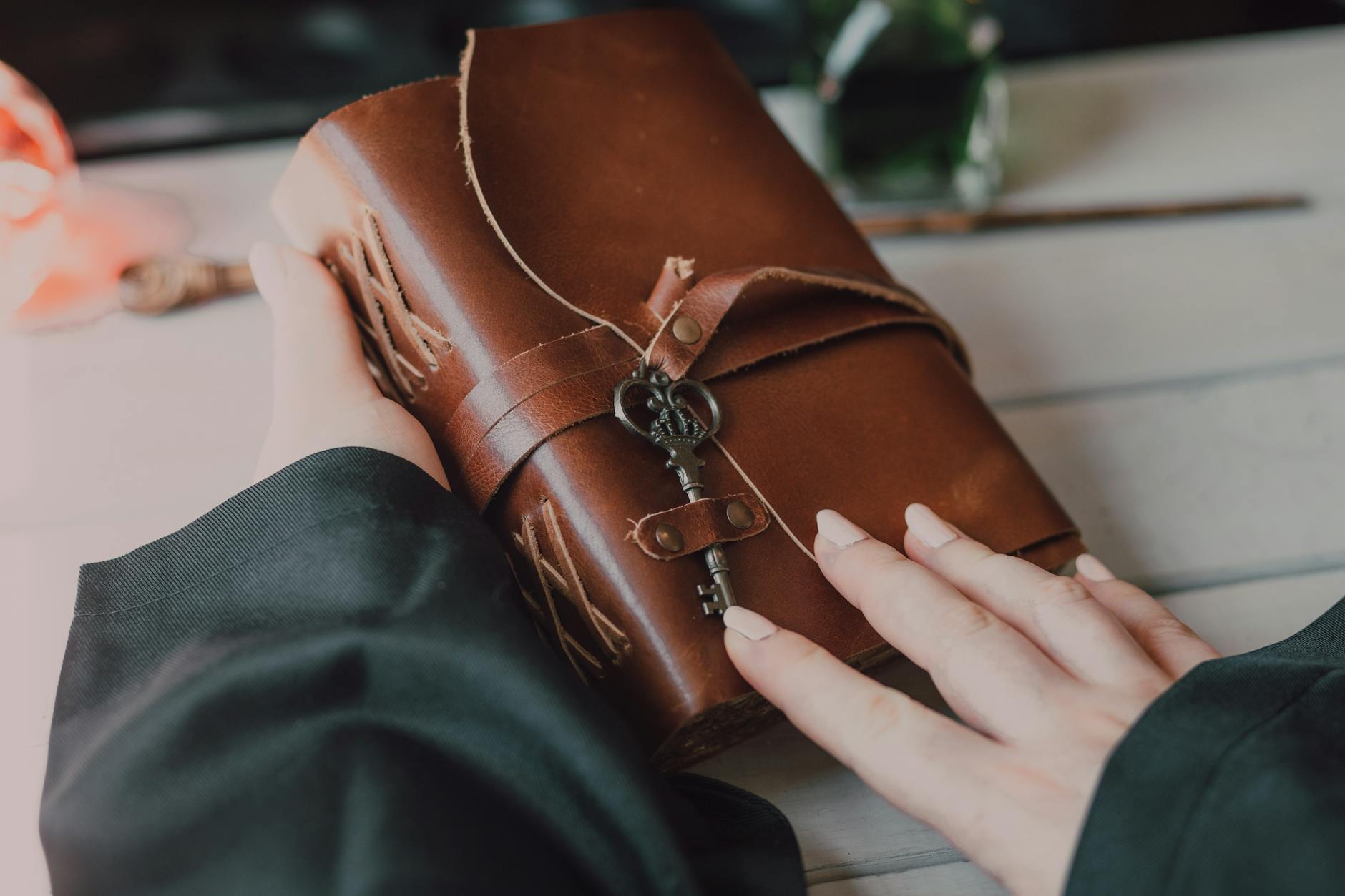 close up shot of a person holding a spell book